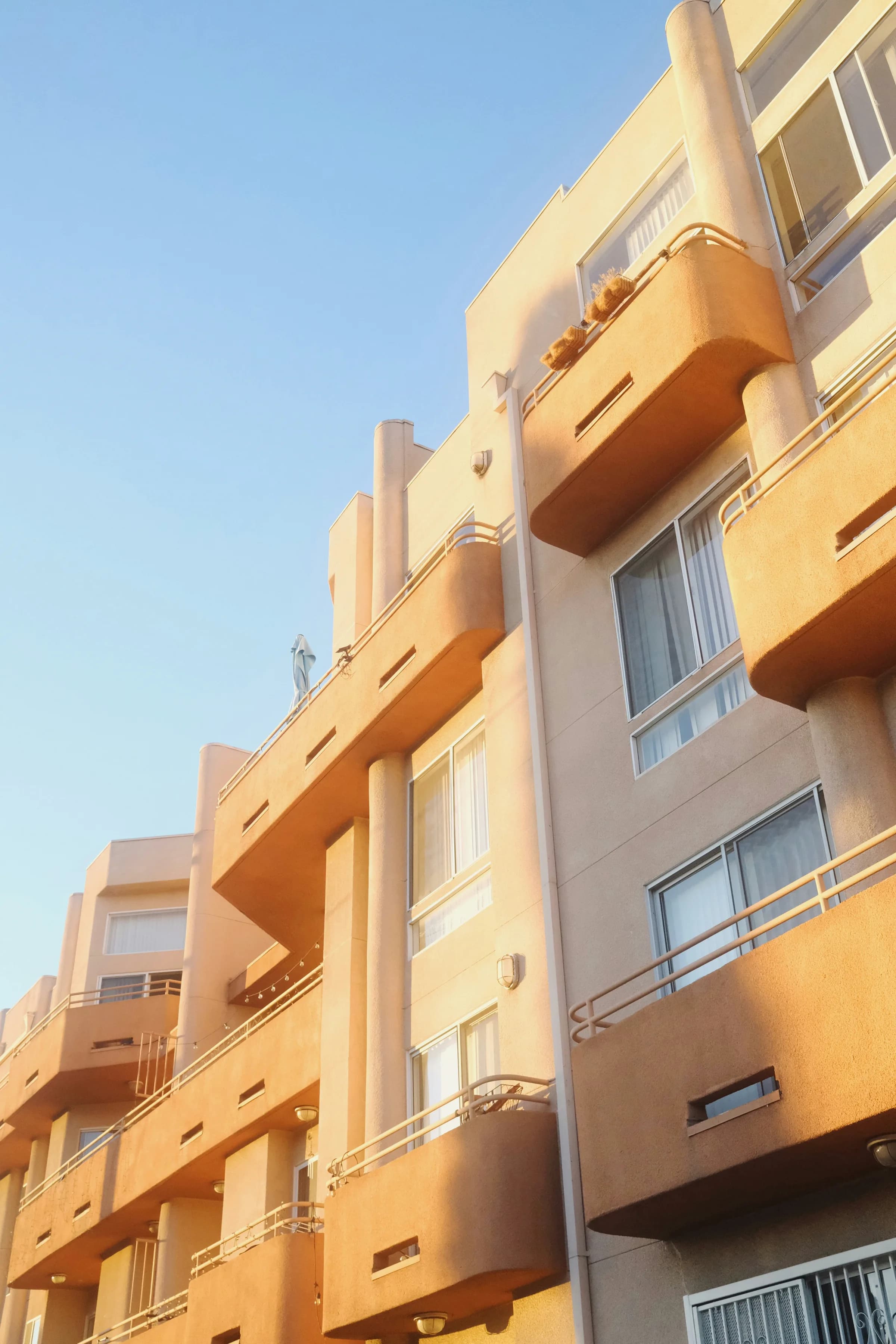 Multistory Los Angeles apartment building with balconies under a clear sky